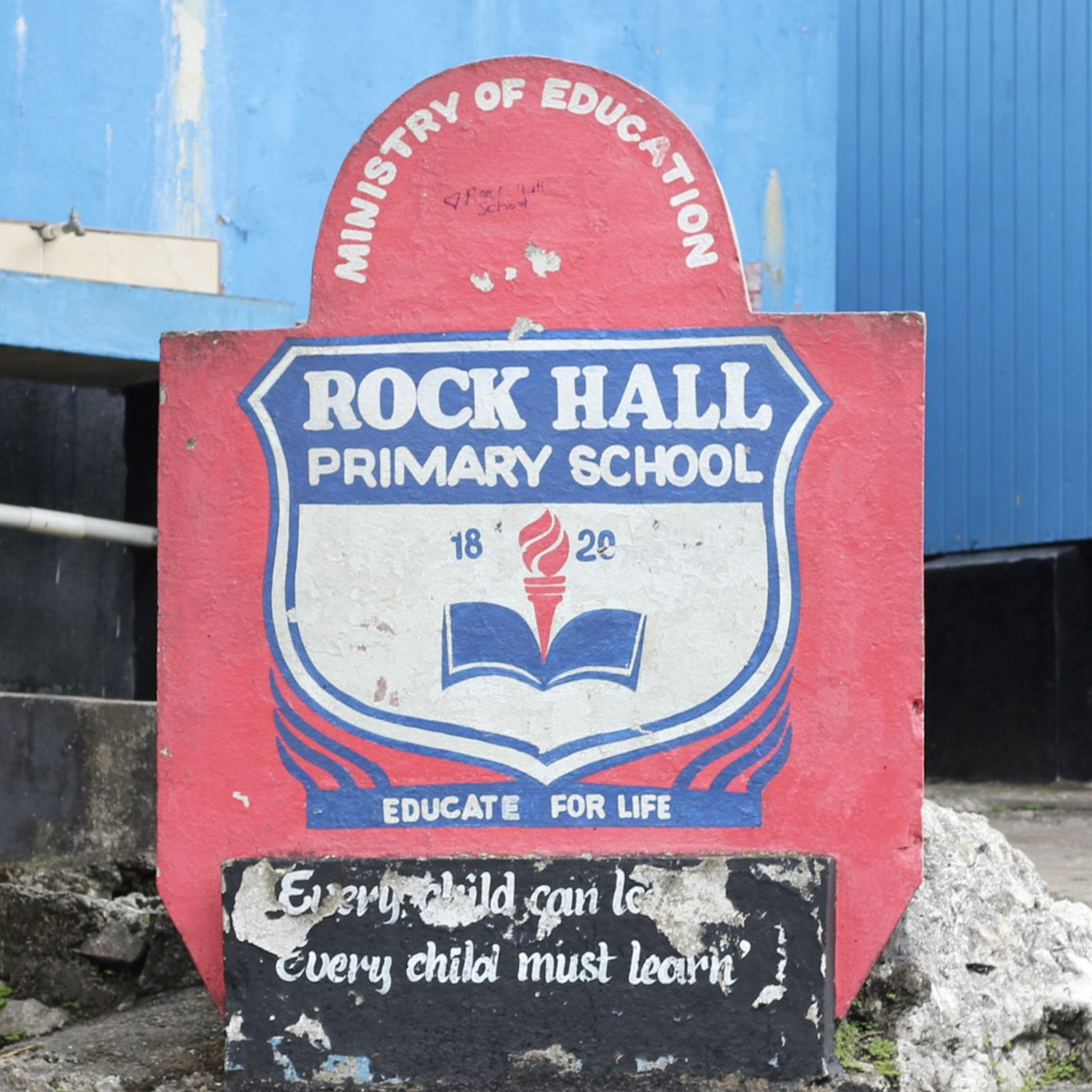 School sign before restoration